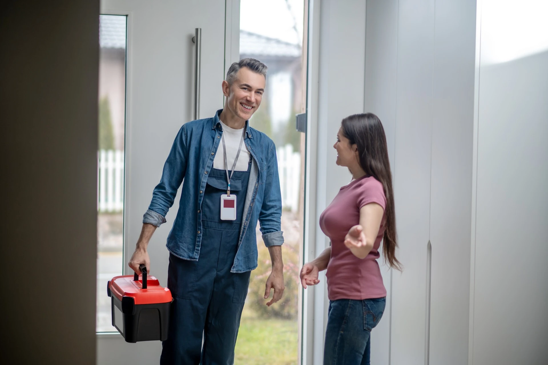 Woman inviting man house with tools